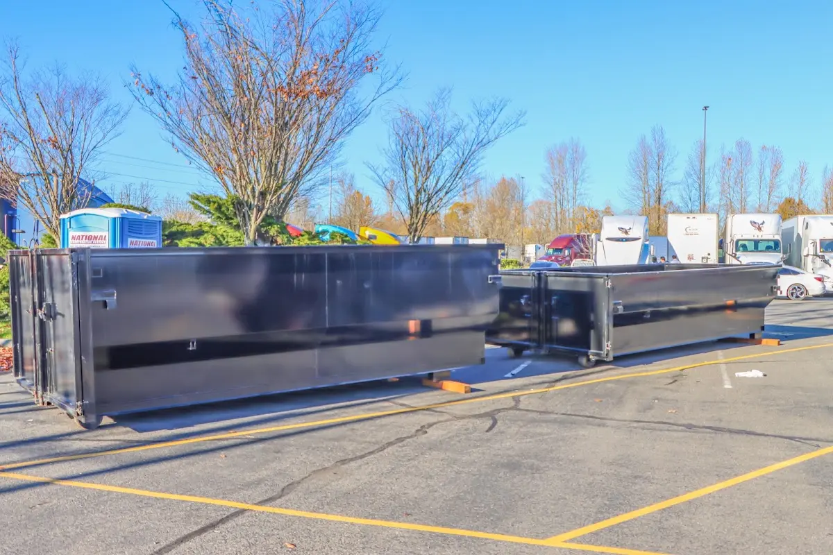 Professional dumpster rental service with roll-off container on residential driveway in Timonium